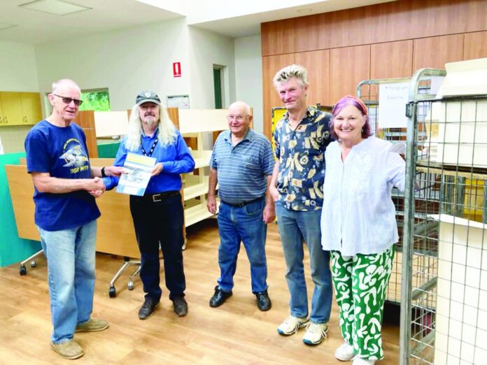 John Partington, Jim Guy, Don Munro, Graeme Ussing, Jo Ussing. John (left) presenting a copy of Aviation at Nhill to Jim Guy (2nd from left) and the Clarinda Library in appreciation of ‘new’ library shelves for the Nhill Book Fair.