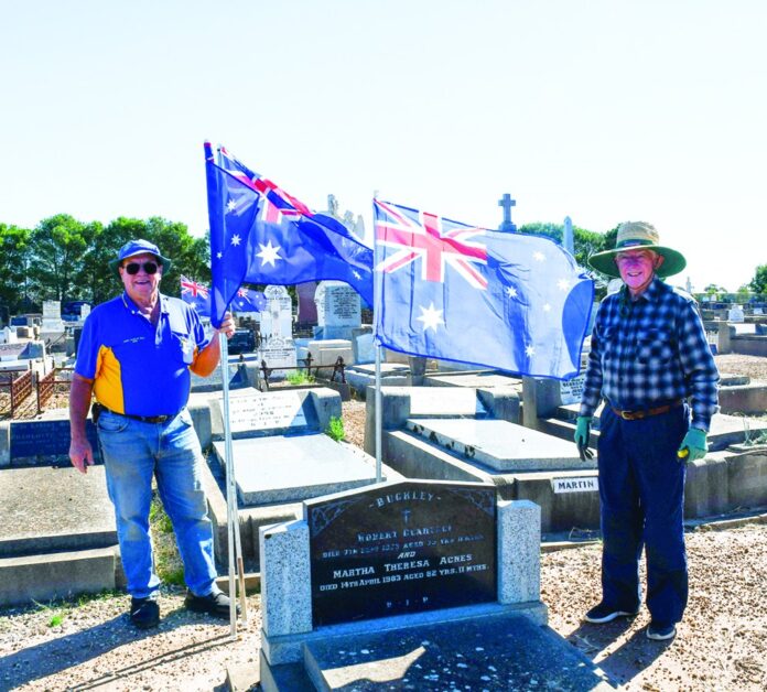 Nhill Lion Bob Blackwood and Nhill RSL Sub-Branch member Bill Howarth work together placing our Australian Flags on graves.