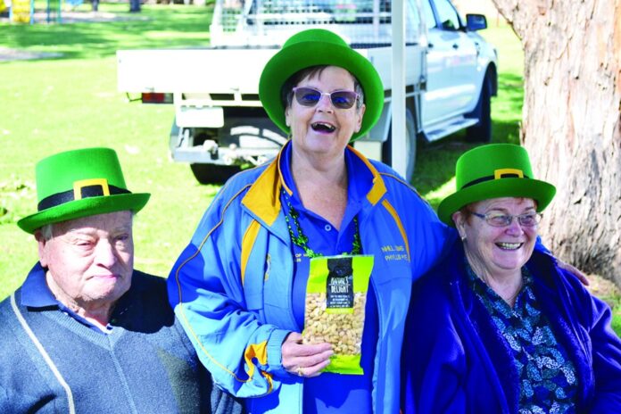 Lion Phyllis Pye and Market Gate volunteers Lion Alan and Maree Kennedy get in the spirit of St Pat’s day wearing their green hats