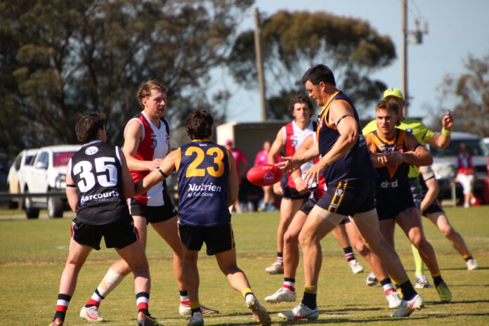 Dan Batson boots the ball clear of congestion.
