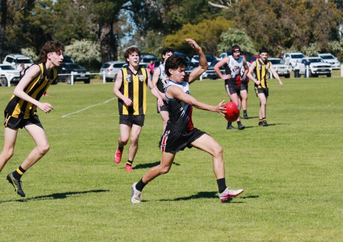 Oscar Dunstan kicks the ball forward. Photos by Chelsea Tink.